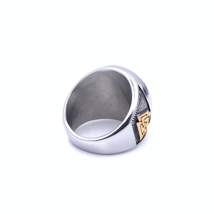 Detailed macro view of retro stainless steel Viking ring with golden Valknut symbol