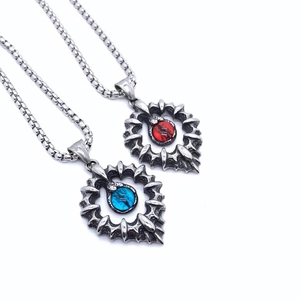 Detailed close-up of gothic dragon claw heart pendants with red and blue eye stones