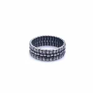 Détail d'une bague punk rétro en acier titane avec texture d'écailles d'os de dragon