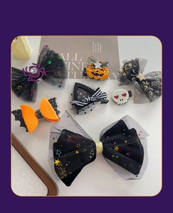 Detail view of Halloween hair clips set featuring pumpkins, bats, and spiders for kids