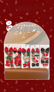 Detailed set of Christmas hair clips with bows, snowman, and reindeer motifs for girls
