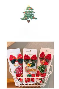 Detail view of Christmas hair clips set with snowman, tree, and red ribbon bows