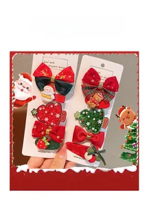 Detail view of handmade Christmas hair clips with bows, snowmen and festive resin charms