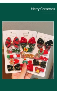 Detailed view of Christmas hair clips featuring Santa and gingerbread man on card