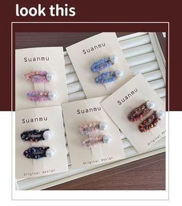 Detail showing five pairs of colorful handmade wool felt BB clips with elegant pearls