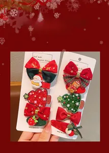 Detailed view of Christmas hair clips with snowman and gingerbread man on red backgrounds