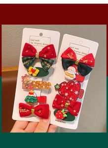 Detail of Christmas hair clip set featuring red velvet bows, snowman, and tree charms