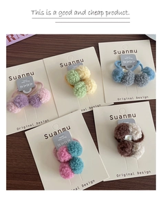 Detail of 5-piece plush ball hair ties set in various colors on a display card
