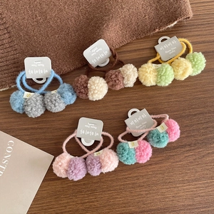 Colorful plush pom pom hair ties for girls featuring elastic bands in various soft pastel tones