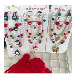 Detail of Christmas kids jewelry sets with Santa, reindeer and snowman bead necklaces