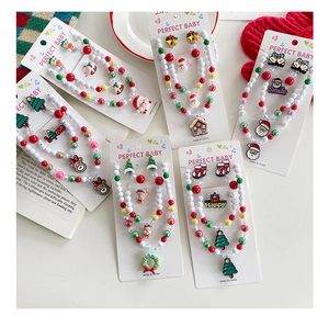 Detail of Christmas jewelry set with Santa and reindeer beads on white display cards
