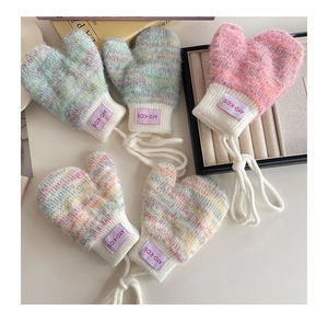Close-up of soft knit toddler mittens with fleece lining and adjustable neck string