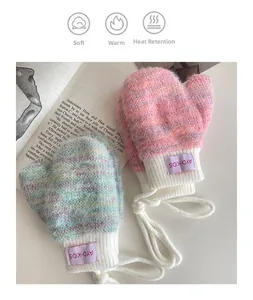 Detail showing thick fuzzy knit baby mittens with ribbed cuffs and anti-lost neck strings