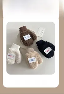 Close-up of fluffy polar fleece kids mittens with letter patch and knit cuffs in four colors