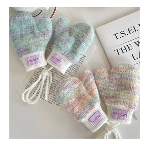 Detailed macro view of soft knit baby mittens with cozy rib cuffs and anti-lost string detail