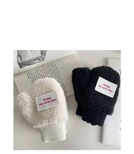 Detail of warm white and black fleece mittens for kids with cozy knit ribbed cuffs