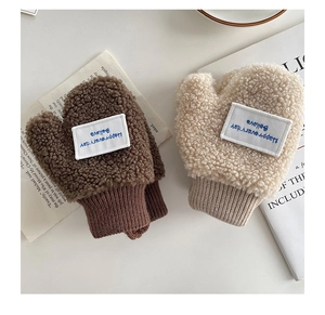 Close-up of fleece mittens featuring a woven patch with 'Happy everyday' lettering