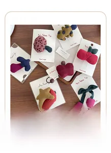 Detailed close-up of handmade fabric hair clips with cherry and mushroom designs