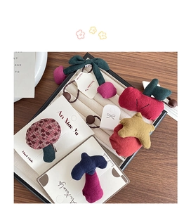 Detail view of handmade fabric hair clips and ties with star and cherry designs