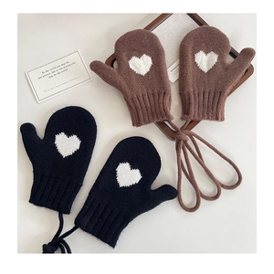 Detail of knitted mittens with heart patterns, long neck strings, and ribbed windproof cuffs