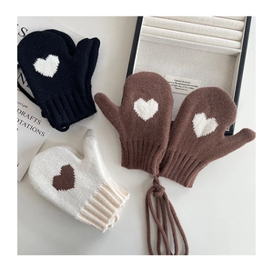 Detailed view of three knitted heart mittens with neck straps for kids' winter warmth