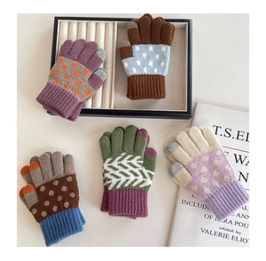 Close-up of colorful knitted winter gloves with ribbed cuffs in various patterns