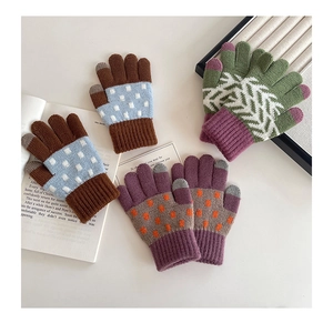 Close-up of knit winter gloves featuring touchscreen fingertips and colorful patterns
