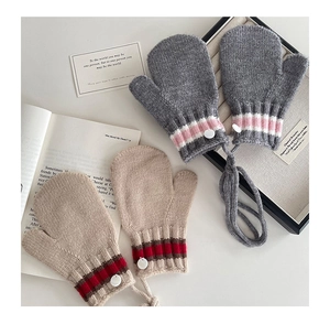 Detailed knit mittens with neck strap and decorative stripes on soft winter fabric