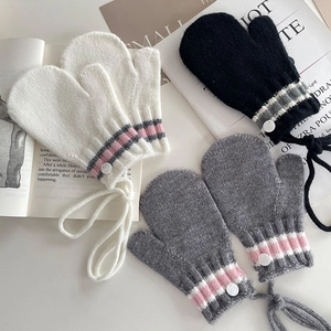 Warm knit children's mittens in black white and grey with neck cord and button detail