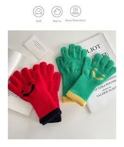 Detail of warm knitted gloves with cute smiley faces and soft plush thermal texture