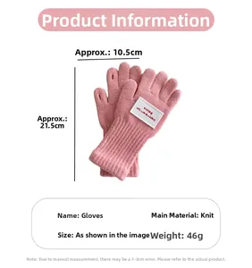Nahaufnahme der rosa gestrickten fingerlosen Handschuhe mit weißem Dekorflicken