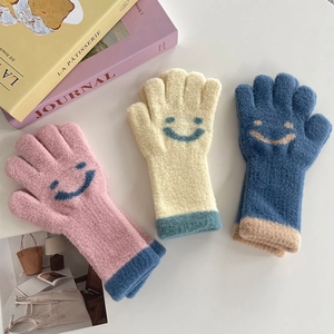 Cozy knit children's gloves with smiley patterns in pink, cream and navy blue colors