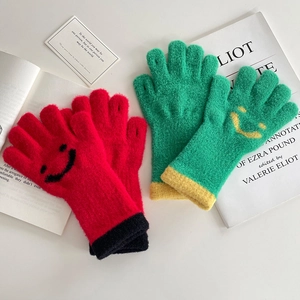 Knitted smiley face winter gloves for kids in red and green colors with plush texture