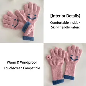 Pink knit touch screen gloves for kids featuring blue smiley face pattern