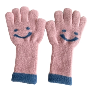 Pink knit gloves for kids with navy blue cuffs and a cute smiling face pattern