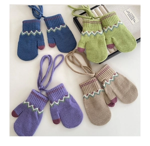 Detailed view of four pairs of colorful knitted mittens with geometric wave patterns