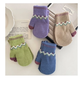 Detailed texture of colorful winter knitted mittens for children with wave jacquard pattern