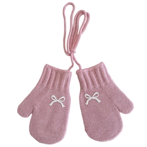 Pink knitted children mittens with white bow and neck cord for winter warmth and comfort