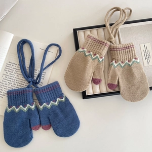 Knitted winter mittens for children with wavy patterns and neck strap in navy and beige