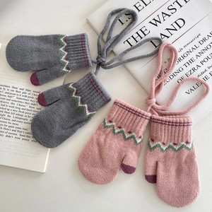 Cozy knit children's winter mittens in grey and pink with wavy pattern and neck string