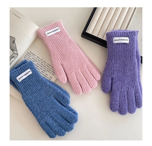 Detailed knit texture and woven label on three-color winter gloves for children