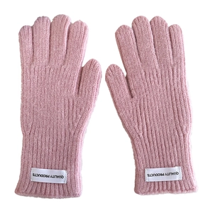 Pink knit children's winter gloves with ribbed texture and quality product label detail