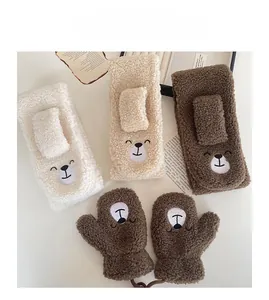 Detailed close-up of soft lamb wool scarf and gloves with cute bear embroidery set