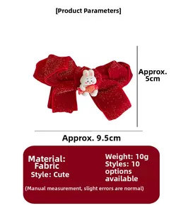 Macro detail of red velvet bow hair clip with cute cartoon rabbit and gold glitter