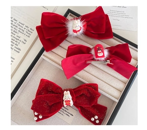Detail of red velvet bow hair clips with cute rabbit charms and pearl tassels for girls