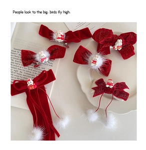 Detailed close-up of red velvet bow hair clips with cute rabbit charms and fur balls
