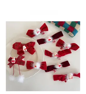 Detail of red New Year bow hair clips featuring cute white rabbits and soft pom-poms