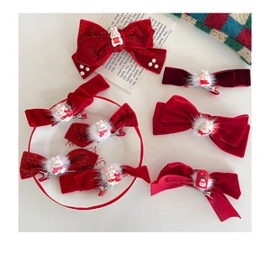 Close-up of red velvet bow hair clips with plush rabbits for Chinese New Year