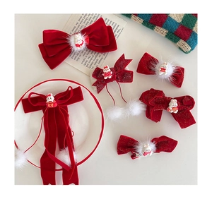Detail of red velvet bow hair clips with cute rabbit and white plush balls for New Year