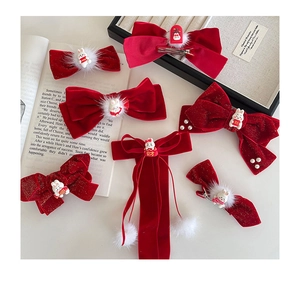 Detailed set of red velvet bow hair clips with plush pom-poms and rabbit resin accents